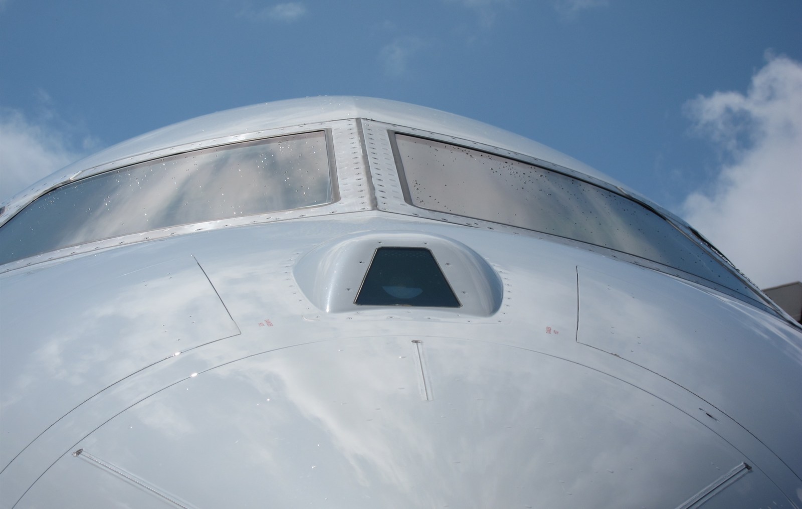 The enhanced vision system camera window on the nose of a business jet