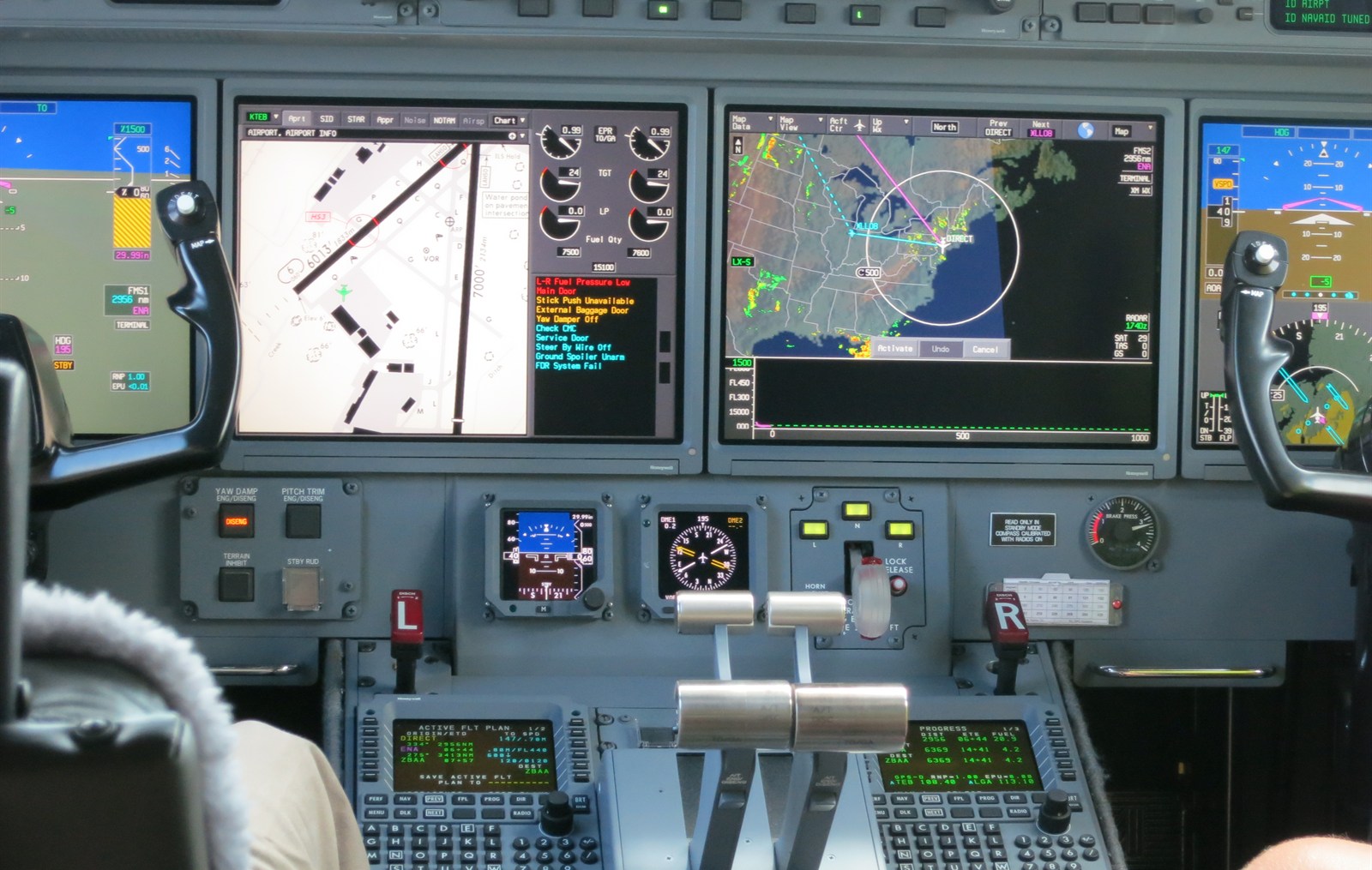 A Gulfstream G550 glass cockpit flight control system with multiple avionics displays
